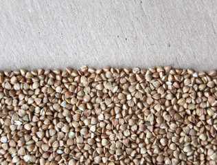 Texture of buckwheat on a cardboard surface. Empty place.