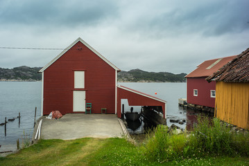 Classic, red Norwegian house and  boat