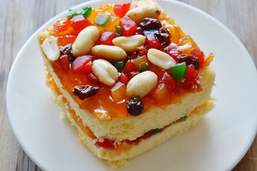 orange butter cake topping peanut and dried fruit salad on plate