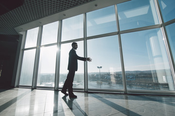 Fototapeta premium Business man move in room with handshake against panoramic windows