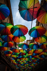 Fototapeta na wymiar Color picture of colorful umbrella roof between buildings