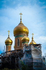 Color picture of golden tinted rooftop church under construction - 132401972