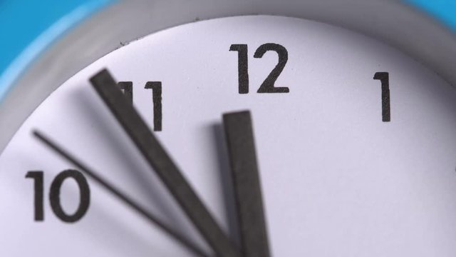 The arrows on the clock  23:55. Close-up