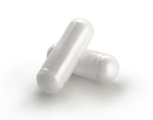 Two white capsule isolated on white background. Close up, copy space, high resolution product. Health care concept