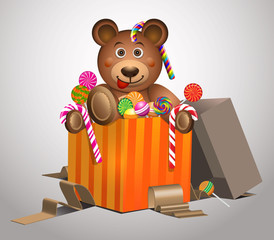 Cute teddy bear with colorful sweets in gift box isolated on white background