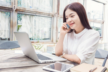young happy casual asian woman using technology