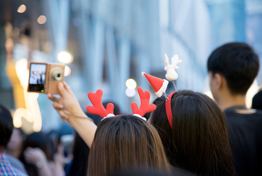 Beautiful young Asian happy woman waring cute hair band enjoying their holiday time together and selfie with friend at christmas and new year holidays.