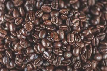 Coffee beans close up macro with selective focus. Vivid colored overhead shot.Concept for freshness, morning, cozy lifestyle.