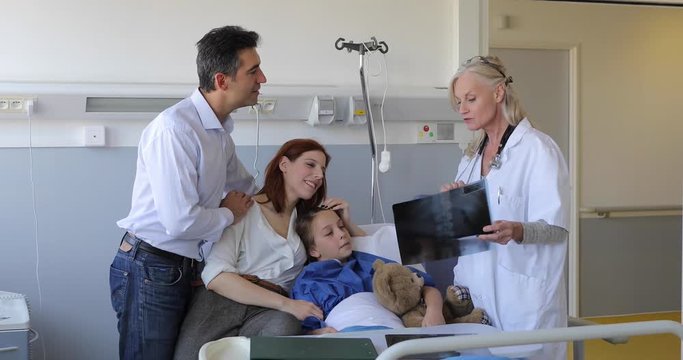 Pediatrician Visiting Parents And Child In Hospital Bed, 4K, UHD movie (3840X2160)