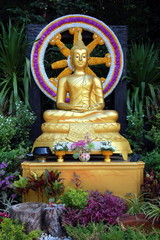 Golden Buddha on a background of the Dharmachakra in the temple complex  Wat Saket (Golden Mounty), Bangkok, Thailand