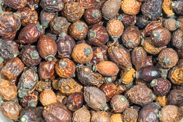 Dried rose hips natural background of warm colors