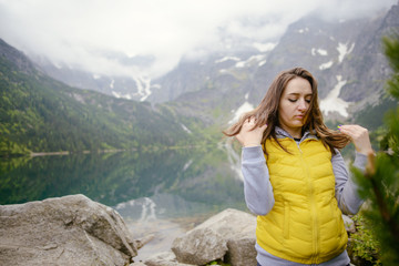 woman relaxing on the lake and mountains sunny landscape