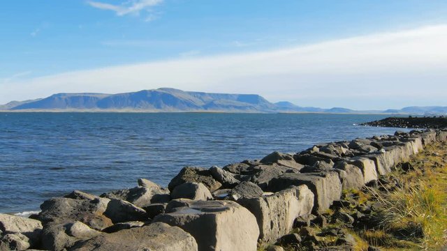 embankment of Atlantic ocean in Reykjavik, view of Esja mountain, in sunny day