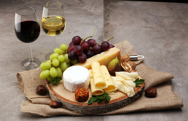 Cheese platter with different cheese and grapes 