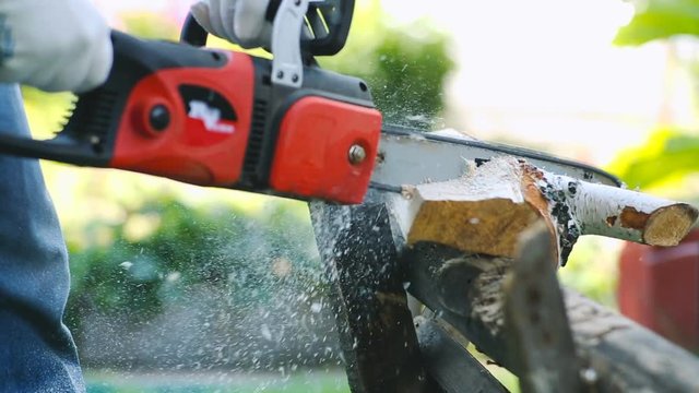 Close-up of working with chainsaw