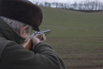 Man shooting with shotgun