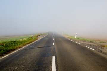 Empty long highway with fog