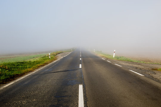 Empty long highway with fog