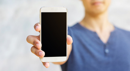 Man holding a smartphone in his hand.