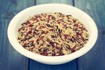 rice in white plate on wooden background