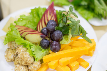 Grapes and cheese with salad.