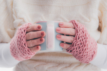 Hot drink in beautiful cup in hands close up