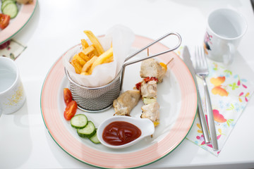 Tasty french fries with barbecue on child birthday