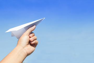 Hand holding rocket paper with blue sky. concept freedom