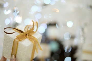 Present gift with bokeh lights and soft focus.