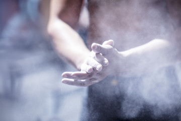 Man applying chalk on his hands