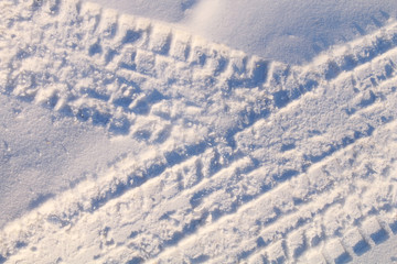 Trace of an automobile tire on a white freshly fallen snow