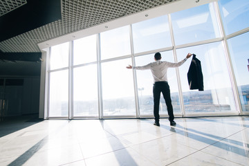 relaxed businessman winner in office with panoramic windows