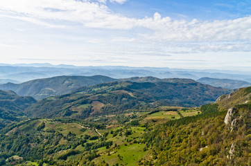 Fototapeta na wymiar Viewpoint on a landscape of mount Bobija, peaks, hills, meadows and green forests, west Serbia