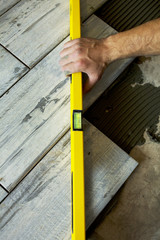 Worker installing Tiles on the Floor