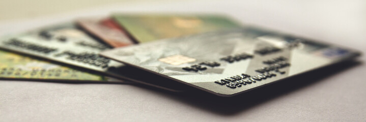 stack of credit cards, close up with selective focus. panorama - obrazy, fototapety, plakaty