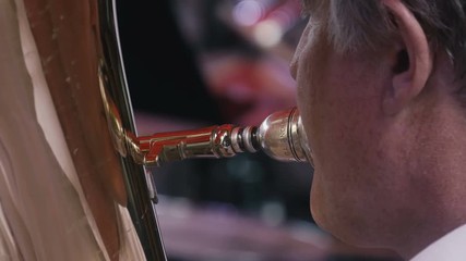 Close-up of Man playing on trombone