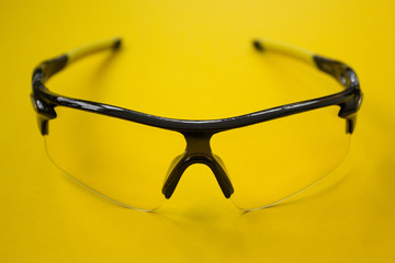 Fototapeta premium Sports bike sunglasses on a yellow background.