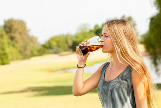 Teenager Drinking A Glass Of Soda