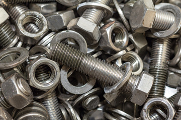 Bolts and screws used in construction. Tightening around the nec