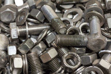 Bolts and screws used in construction. Tightening around the nec