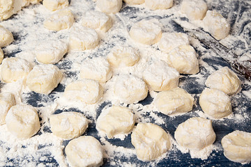 Making homemade gnocchi. Uncooked trickled pastries in flour