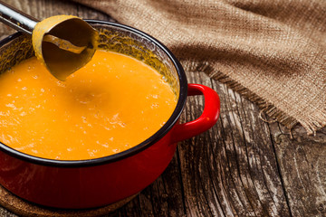 Pumpkin puree on wooden background