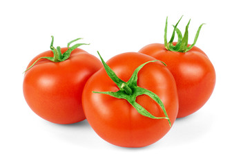 three fresh tomatoes with green leaves isolated on white backgro