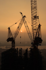 Obraz premium The construction of building in the sunset