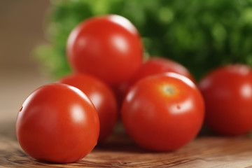 cherry tomatoes and frisee lettuce on cutting board, organic vegetables