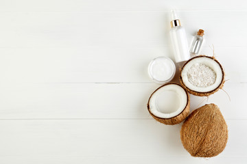Fototapeta na wymiar Homemade coconut products on white wooden table background. Oil,