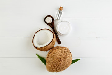 Homemade coconut products on white wooden table background. Oil,