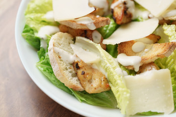 macro shot of fresh homemade caesar salad with chicken, shallow depth of field