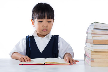 Asian Chinese little girl wearing school uniform studying