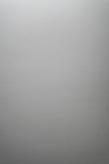 Fototapeta premium white even cement plaster wall with light gradient, background photo